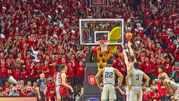 Rutgers students wave their arms during an opposing free throw